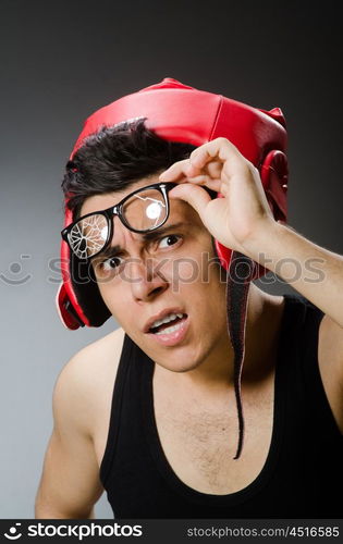 Funny boxer with red gloves against dark background