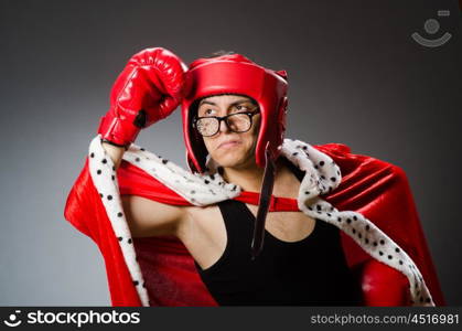 Funny boxer with red gloves against dark background