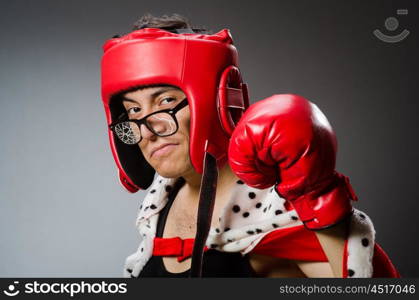 Funny boxer with red gloves against dark background