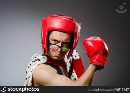 Funny boxer with red gloves against dark background