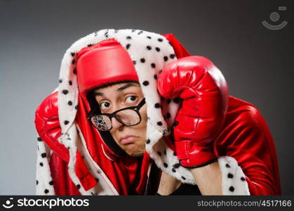 Funny boxer with red gloves against dark background