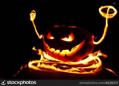 Funny burning Halloween pumpkin isolated on black background
