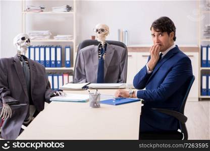 Funny business meeting with boss and skeletons. The funny business meeting with boss and skeletons