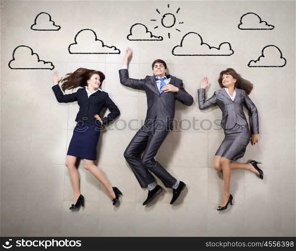 Funny business people. Funny businesspeople lying on floor and acting like running