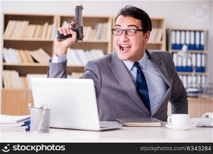 Funny businessman with gun in office