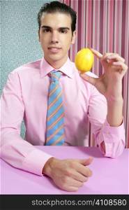 Funny businessman with lemon fruit on his hand in wallpaper background