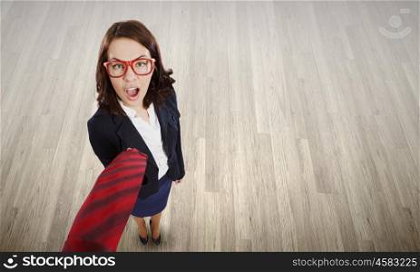 Funny businesswoman. Top view of businesswoman pulling tie of boss