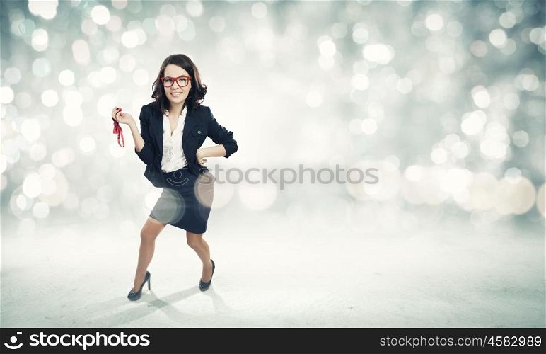 Funny businesswoman. Young funny businesswoman in suit against bokeh background