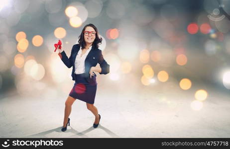 Funny businesswoman. Young funny businesswoman in suit against bokeh background