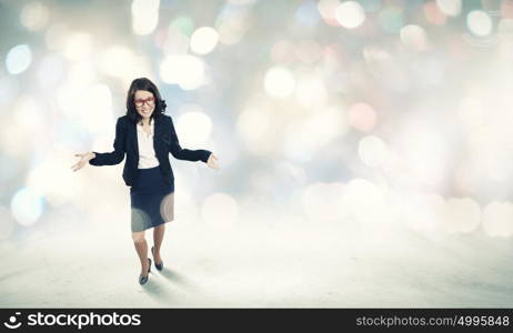 Funny businesswoman. Young funny businesswoman in suit against bokeh background