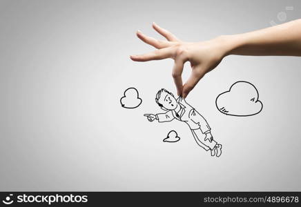 Funny caricature. Close up of human hand and sketch of businessman