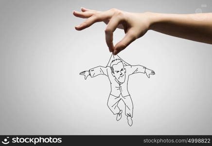 Funny caricature. Close up of human hand catching running away businessman