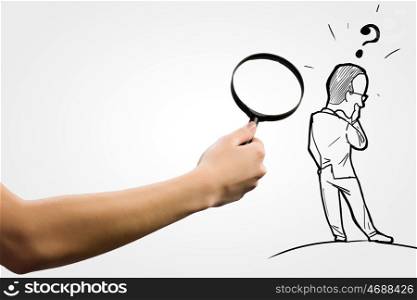 Funny caricature. Human hand with magnifying glass and caricature of businessman