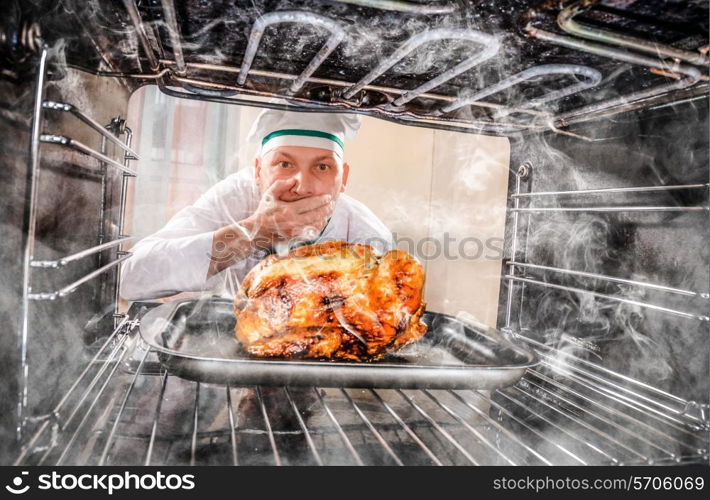 Funny chef overlooked roast chicken in the oven, so she had scorched, view from the inside of the oven. Cook perplexed and angry. Loser is destiny!