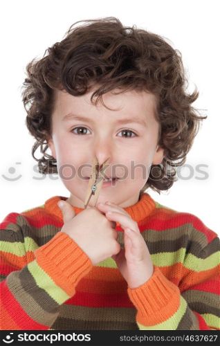 Funny child covering the nose with a pin isolated on a white background