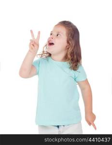 Funny child girl making the symbol winner isolated on a white background