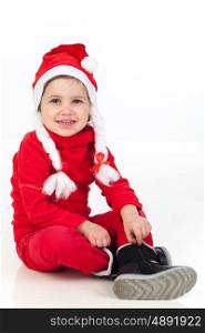 Funny child wearing red christmas hat isolated on a white background