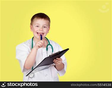 Funny child with doctor uniform on a yellow background