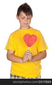 Funny child with yellow t-shirt with a big lollipop isolated on white background