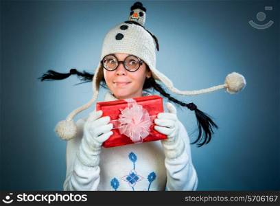 Funny christmas girl with a gift in their hands