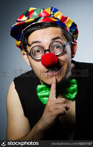 Funny clown against the dark background