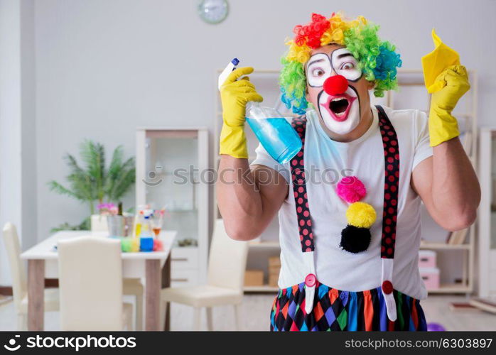 Funny clown doing cleaning at home