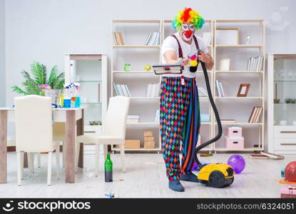 Funny clown doing cleaning at home