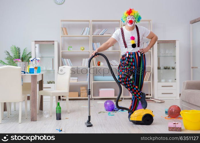 Funny clown doing cleaning at home