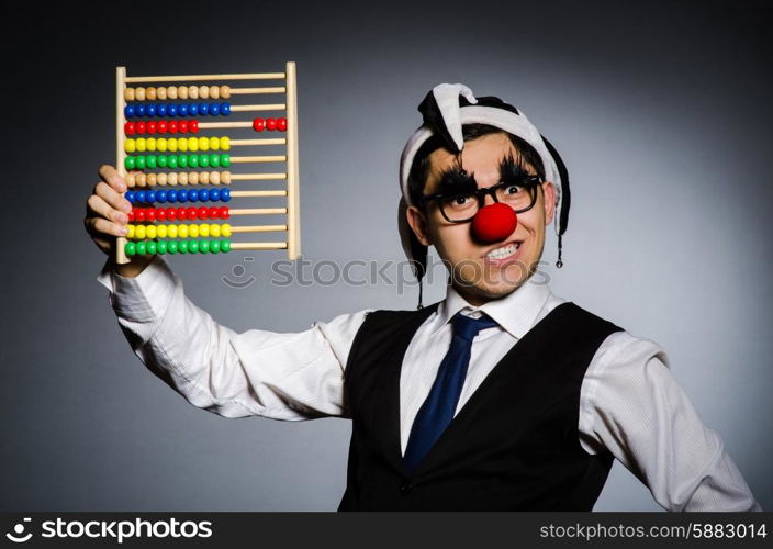 Funny clown with abacus in accounting concept