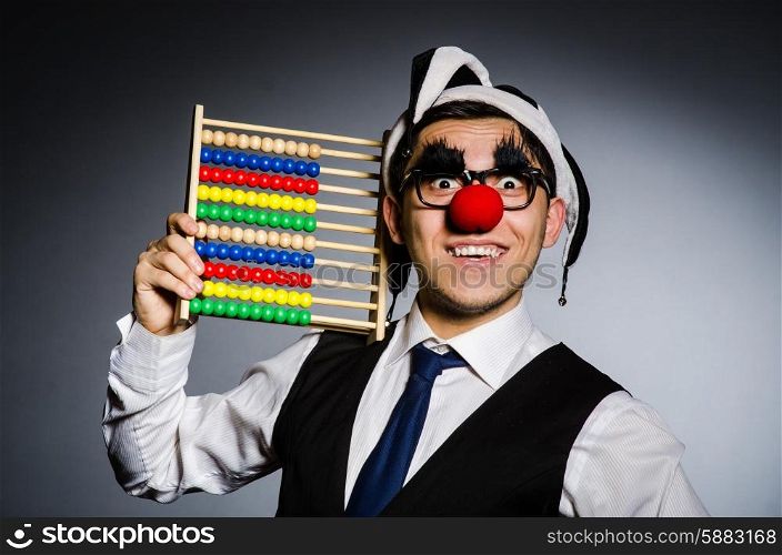 Funny clown with abacus in accounting concept