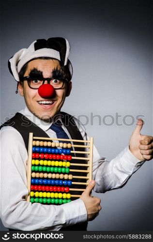 Funny clown with abacus in accounting concept