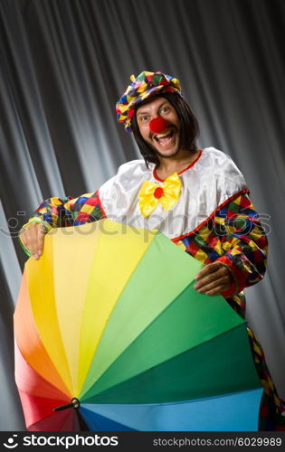 Funny clown with colourful umbrella