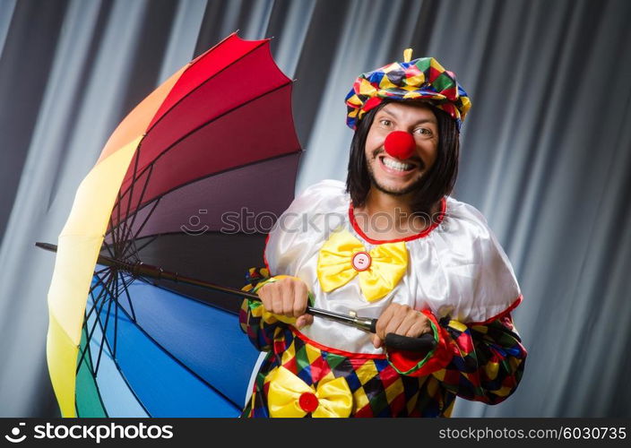 Funny clown with colourful umbrella