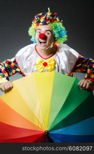 Funny clown with colourful umbrella