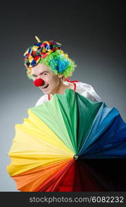 Funny clown with colourful umbrella