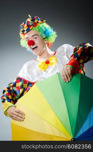 Funny clown with colourful umbrella