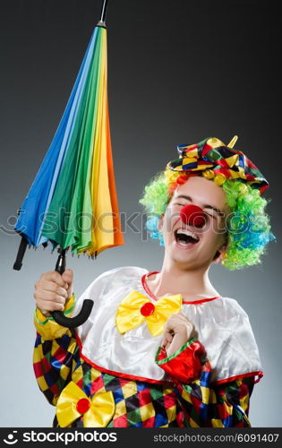 Funny clown with colourful umbrella