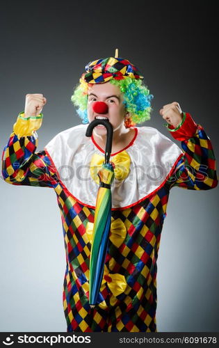 Funny clown with colourful umbrella