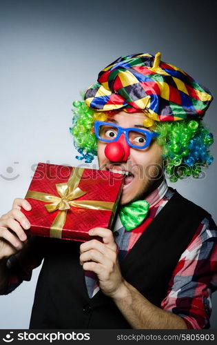 Funny clown with red giftbox