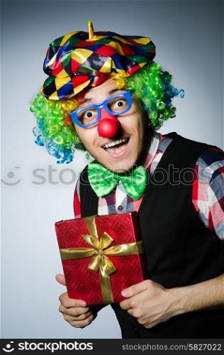 Funny clown with red giftbox