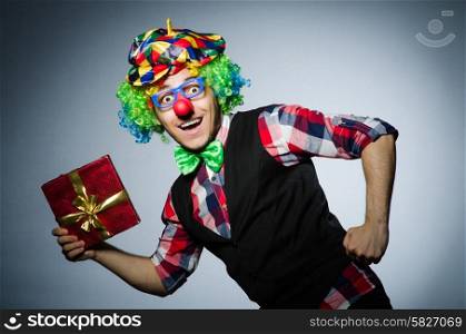 Funny clown with red giftbox
