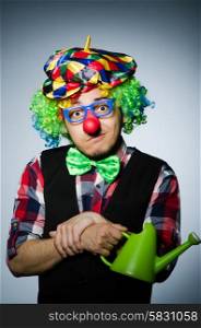 Funny clown with watering can