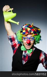 Funny clown with watering can
