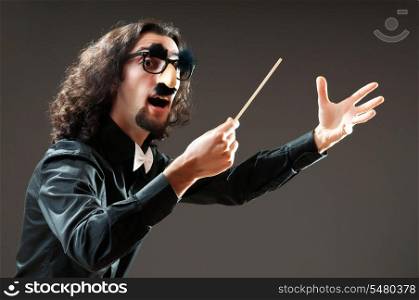 Funny conductor against dark background