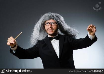 Funny conductor with long grey hair