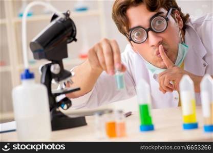 Funny crazy chemist doing experiments and tests