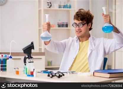 Funny crazy chemist doing experiments and tests. The funny crazy chemist doing experiments and tests