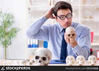 Funny crazy professor studying human skeleton