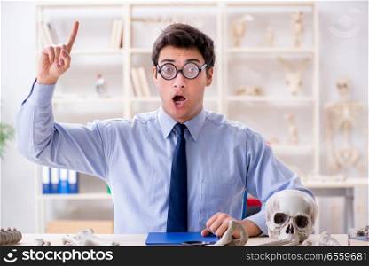Funny crazy professor studying human skeleton