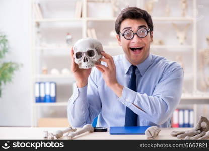 Funny crazy professor studying human skeleton